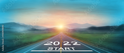 New year 2022 or start straight concept. word 2022 written on the road in the middle of asphalt road at sunset. Concept of planning and challenge, business strategy, opportunity and new life change