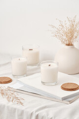 Wall Mural - Handmade scented candles in a glass with a wooden lid. Soy wax candles with a wooden wick. Front view.