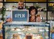 © Rawpixel.com - Cake cafe owners with open sign