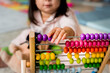 © Rawpixel.com - Little girl playing abacus for counting practice