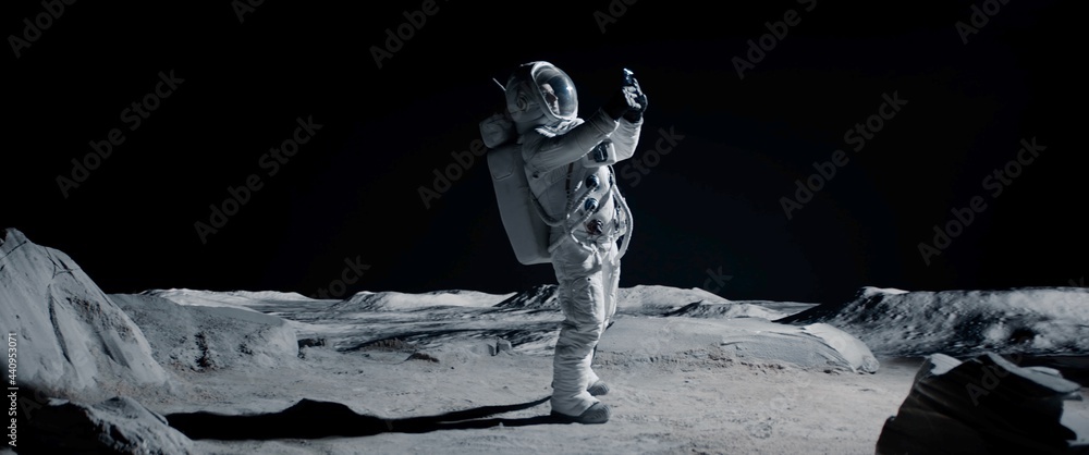 WIDE Male actor in astronaut suit making selfie on a Moon Lunar movie shooting set. Shot with 2x anamorphic lens - obrazy, fototapety, plakaty 