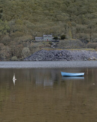 Sticker - Beautiful view of a blue canoe peacefully swimming in the lake