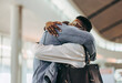 © Jacob Lund - Couple meeting at airport arrival gate