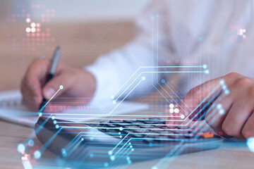 A research and development specialist computing the data to create a new approach to develop high tech business. Technological icons over the desk with calculator.