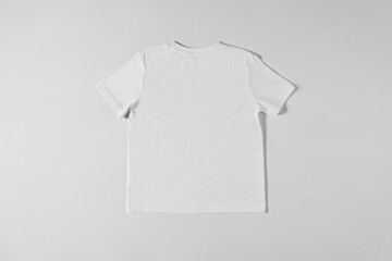Wall Mural - White T-shirt lying on a light background
