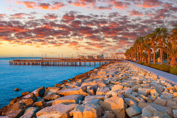 Wall Mural - Embankment in Cyprus. Beach and promenade on a Mediterranean island. Limassol on a summer evening. Evening panorama of Limassol. Cyprus tour. Limassol resort. Holidays in Cyprus.