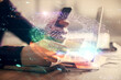 © peshkova - Multi exposure of man's hands holding and using a digital device and data theme drawing. Innovation concept.