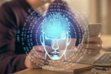 Double exposure of man's hand holding and using a digital device and brain hologram drawing. Data concept.