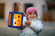 © Irina Schmidt - Close-up of little kid girl holding selfmade lanterns with candle for St. Martin procession. Healthy toddler child happy about children and family parade in kindergarten. German tradition Martinsumzug