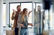 © Drazen - Young woman and her husband feeling excited after moving in their new home.
