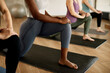 © Drazen - Unrecognizable athletic women doing stretching exercises while warming up at health club.