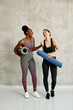 © Drazen - Full length of young cheerful athletic women laughing and having fun together.