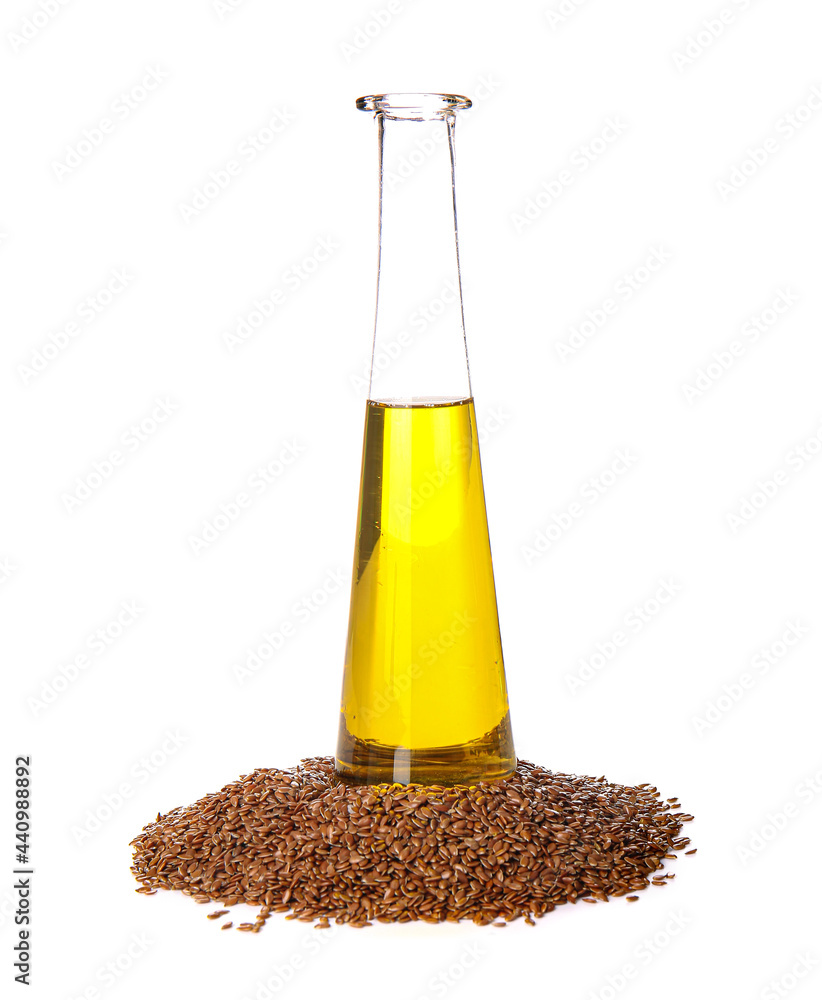 Bottle with flax oil and seeds on white background
