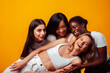 © iordani - diverse multi nation girls group, teenage friends company cheerful having fun, happy smiling, cute posing on yellow background, lifestyle people concept, african-american, asian and caucasian