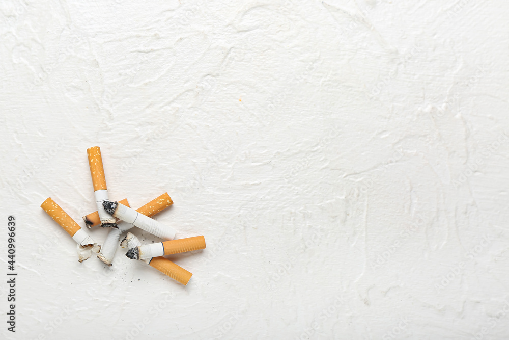 Many cigarettes on light background