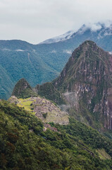 Wall Mural - View of famous Machu Picchu lost city from The Door of the Sun . Ruins of ancient inca civilization in the sacred valley of Cusco Province. Peru, South America