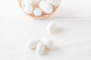 Wall Mural - white silkworm cocoons shells, source of silk fabric in the basket