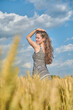 © ivana - Young girl with long hair in a field