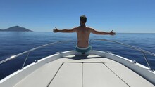 Slow Motion - Man Spreading Out His Arms While Sitting On The Front Of The Boat