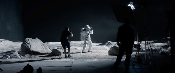 Wall Mural - wide behind the scenes, cinematographer shooting viral video for social account on a large moon land