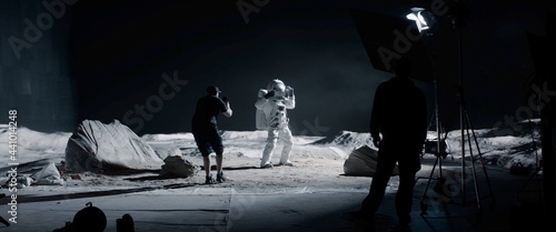 WIDE Behind the scenes, cinematographer shooting viral video for social account on a large Moon landing set. Virtual production with LED screens