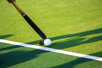 Canvas Print - Field hockey player on artificial grass play field.