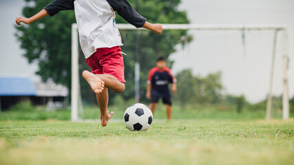 action sport outdoors of diversity of kids having fun playing soccer football for exercise in community rural area under the twilight sunset sky