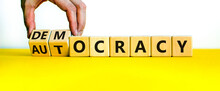 Democracy Or Autocracy Symbol. Businessman Turns Wooden Cubes And Changes The Word Autocracy To Democracy. Beautiful White Background, Copy Space. Business And Democracy Or Autocracy Concept.