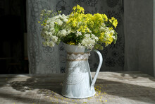 Wild Flower Bouquet In White Jug On Blue Vintage Wooden Table. Still Life With Bouquet Of Spring Wildflowers.