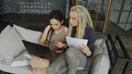 Lesbian couple discussing over financial bills while using internet