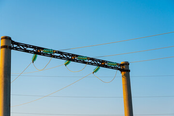 Electric poles with wires on the background of the sky.