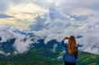 Young girl stand on viewpoint with white cloud and sunset sky at border of Thailand and Myanmar, Chiang Rai province norther of Thailand