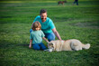 © Volodymyr - Father and son with dog at park. Happy family lifestyle concept.