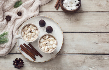 Two cups of coffee on old wooden table close up. Winter still life