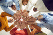 © Studio Romantic - Diverse multiethnic people group of different age and nationality holding hands together. Shot with view from bottom. Friendship, relationship and communication. Teamwork and teambuilding