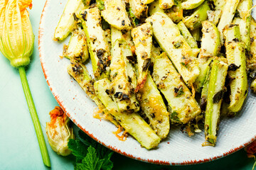 Canvas Print - Roasted zucchini sticks with greens