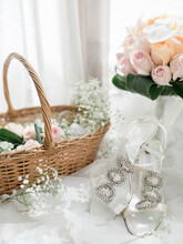 Wedding Shoes And Bouquet In A Basket