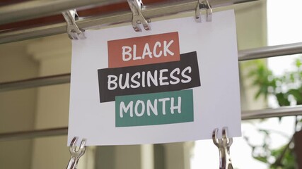 Wall Mural - Black business month sign were attached in the public space