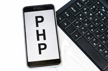 phone on screen letters php next to laptop.