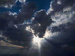 Low angle shot of a blue cloudy sky and bright sunlight at daytime - perfect for wallpapers