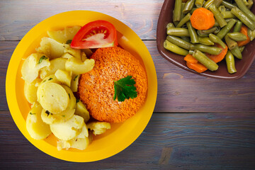 Wall Mural - meatball with potatoes on a wooden background