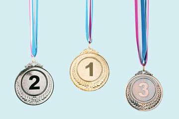 three medals (gold,silver,bronze) on blue background.concept of award and victory.copy space