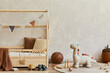 © FollowTheFlow - Stylish composition of cozy scandinavian child's room interior with creative wooden bed, plush and wooden toys and textile hanging decorations. Neutral creative wall. Copy space. Template. .