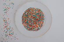 Hands Holding Plate Full Of Colorful Confetti
