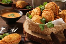 Crispy Puff With Chicken And Vegetable Stuffing. Accompanied With Spicy Peanut Sauce.