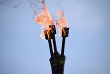 Close-up Of Flaming Torch Against Clear Sky