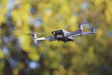 Low Angle View Of Drone Flying In Front Of Trees