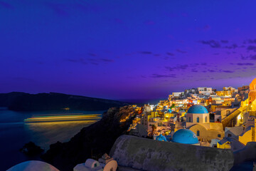 Greece Santorini island in Cyclades, wide view of white washed colorful houses at night