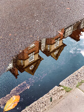 Reflection Of Building In Puddle