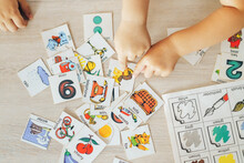 Children Hands Touching White Cards Of Letters Numbers And Pictures For Little Kids On Table. Time To Learn. Education Concept. Flat Lay